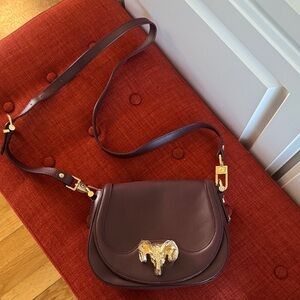 C. Wonder Burgundy Cross Body Bag with Gold Ram Accent